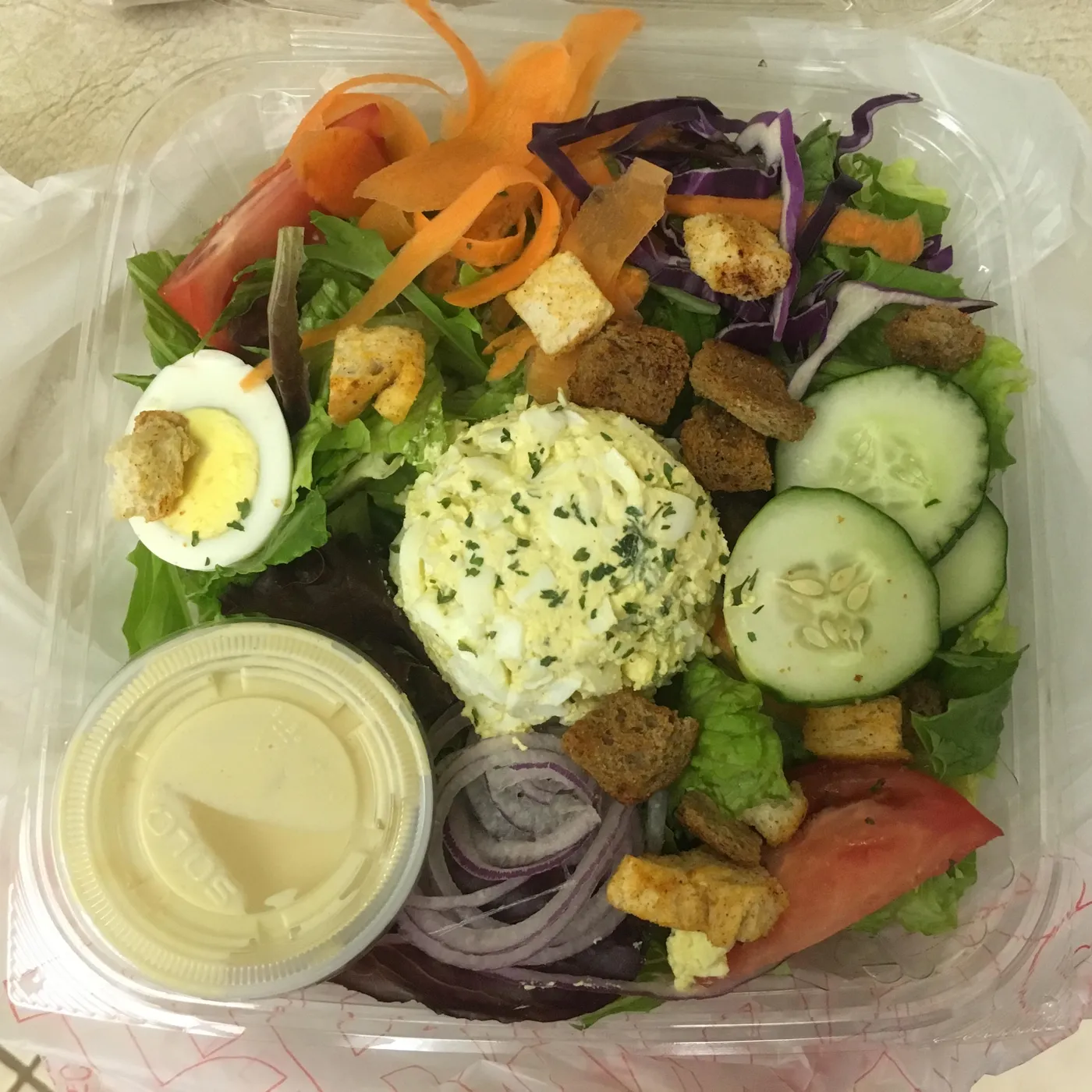 Salad with egg, cucumber and dressing