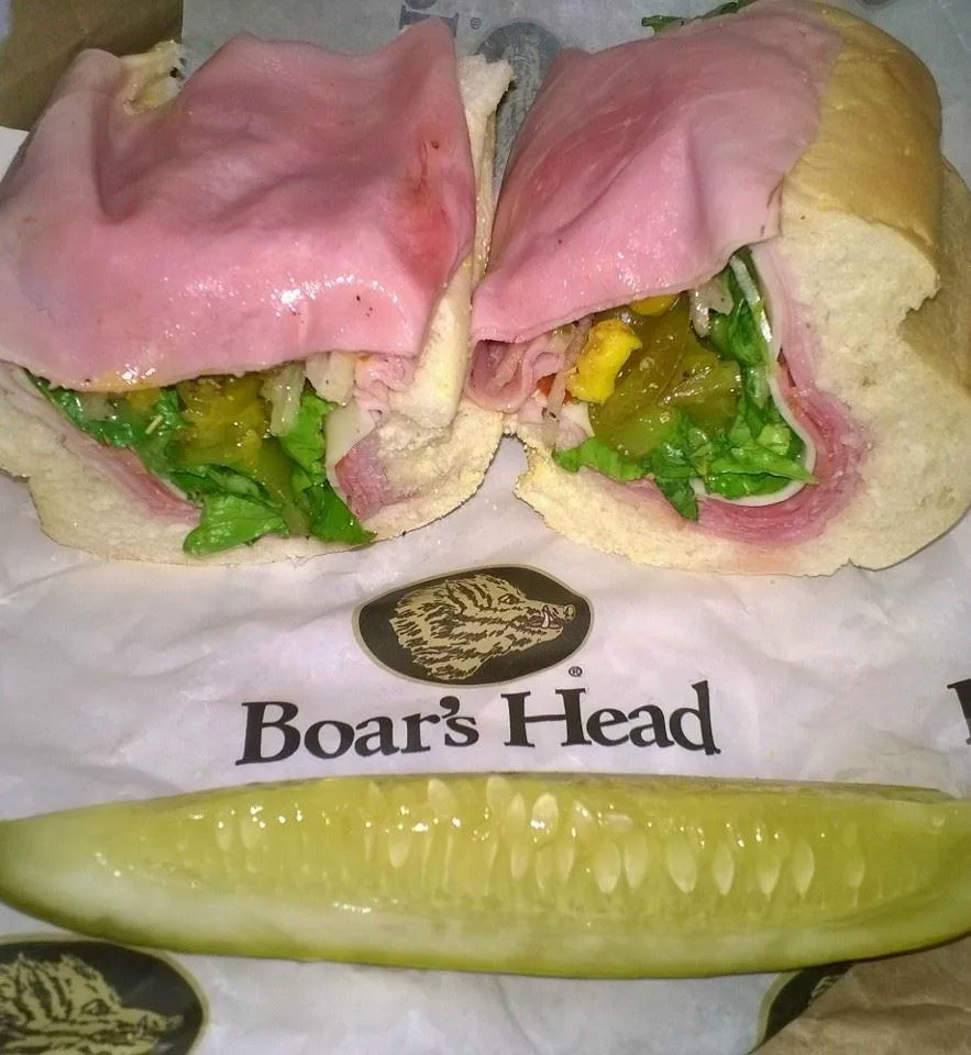 Boar's Head hoagies stacked with meat and tomato